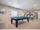 Entertaining game room featuring a pool table, kitchenette, and modern design elements at 18940 E 96Th Pl, Commerce City, CO 80022