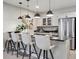 Eat-in kitchen bar area featuring counter seating, pendant lights, stainless steel appliances, and modern finishes at 18940 E 96Th Pl, Commerce City, CO 80022