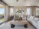 Comfortable living room with large windows, stylish decor, and neutral tones at 18940 E 96Th Pl, Commerce City, CO 80022