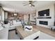 Open-concept living room with a fireplace, entertainment center, and hardwood floors at 18940 E 96Th Pl, Commerce City, CO 80022