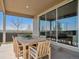 Covered patio with an outdoor dining table and chairs overlooking an open lawn at 18940 E 96Th Pl, Commerce City, CO 80022