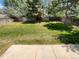 Green backyard features a lush lawn, mature trees, and privacy fence at 5966 S Winnipeg St, Aurora, CO 80015