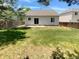 Grassy backyard with privacy fence and sliding glass door at 5966 S Winnipeg St, Aurora, CO 80015