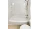 Clean and simple bathroom featuring a shower and tub with built-in shelves at 5966 S Winnipeg St, Aurora, CO 80015