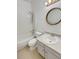 Bright bathroom with a tub and shower combo, and a round decorative mirror at 5966 S Winnipeg St, Aurora, CO 80015
