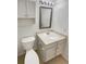 Bathroom with white cabinets, a framed mirror, and a white sink at 5966 S Winnipeg St, Aurora, CO 80015