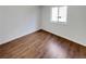 Bedroom with modern floors, neutral walls, and a large window at 5966 S Winnipeg St, Aurora, CO 80015
