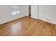 Bedroom with modern floors, neutral walls, and a large window at 5966 S Winnipeg St, Aurora, CO 80015