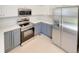 Well-lit kitchen featuring modern appliances, stainless steel refrigerator, and stylish cabinets at 5966 S Winnipeg St, Aurora, CO 80015