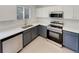 Kitchen with stainless steel appliances and modern two-tone cabinetry at 5966 S Winnipeg St, Aurora, CO 80015