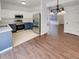View of the kitchen leading into the living area with stainless steel appliances at 5966 S Winnipeg St, Aurora, CO 80015