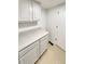 Bright laundry room with cabinets, ample countertop space and tile flooring at 5966 S Winnipeg St, Aurora, CO 80015