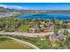 Aerial view showcasing property's location near serene lake, mature trees, and well maintained green spaces at 15325 W 32Nd Ave, Golden, CO 80401