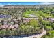 Aerial view of property near golf course with pond showcasing surrounding landscape, mature trees and nearby neighborhood at 15325 W 32Nd Ave, Golden, CO 80401