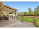 Relaxing covered back deck featuring comfortable seating, string lights, and views of the well manicured and spacious backyard at 15325 W 32Nd Ave, Golden, CO 80401