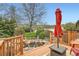 Wooden deck overlooks the koi pond and landscaped backyard with mature shade trees and lush grass at 15325 W 32Nd Ave, Golden, CO 80401