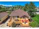 A cozy backyard deck features outdoor dining and a lounge area, perfect for relaxing or entertaining outdoors at 15325 W 32Nd Ave, Golden, CO 80401