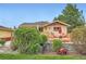 Cozy backyard features a wooden deck with patio seating, a grill, and lush landscaping at 15325 W 32Nd Ave, Golden, CO 80401