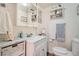 Charming bathroom with white vanity, decorative shelves, and neutral accents, offering a clean and stylish space at 15325 W 32Nd Ave, Golden, CO 80401