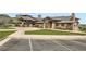 Beautiful exterior of the clubhouse featuring stonework, covered entries, and manicured landscaping at 15325 W 32Nd Ave, Golden, CO 80401