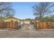Gated driveway leads to a yellow house, garage, and basketball hoop at 15325 W 32Nd Ave, Golden, CO 80401