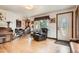 Inviting living room featuring hardwood floors, large windows, and comfortable seating, providing a warm and welcoming atmosphere at 15325 W 32Nd Ave, Golden, CO 80401
