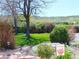 Landscaped front yard featuring beautiful flower gardens, mature trees, and a welcome sign at 15325 W 32Nd Ave, Golden, CO 80401