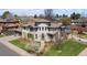 An impressive aerial view of a beautiful home with a manicured lawn and a circular driveway at 5455 E Cedar Ave, Denver, CO 80246