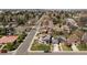 An aerial view showcases a beautiful neighborhood with a mix of modern and traditional homes and mature trees at 5455 E Cedar Ave, Denver, CO 80246