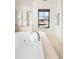 Luxurious soaking tub is set beneath a window in a neutral and elegant bathroom at 5455 E Cedar Ave, Denver, CO 80246