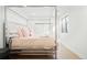 Bright bedroom with a four poster bed, a window and sleek hardwood floors at 5455 E Cedar Ave, Denver, CO 80246