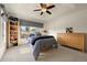 Spacious bedroom with a ceiling fan, large window and ample dresser storage at 5455 E Cedar Ave, Denver, CO 80246