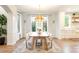 Bright dining room featuring hardwood floors and statement lighting fixture at 5455 E Cedar Ave, Denver, CO 80246