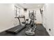 A home gym featuring a treadmill, elliptical, and other exercise equipment in a well-lit room at 5455 E Cedar Ave, Denver, CO 80246