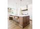 Gorgeous kitchen featuring a large island, custom cabinetry, and stainless steel appliances at 5455 E Cedar Ave, Denver, CO 80246