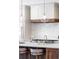 Bright kitchen featuring white cabinetry, light subway tile backsplash, and modern globe pendant lights at 5455 E Cedar Ave, Denver, CO 80246