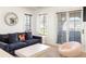 Bright living room featuring a comfortable sofa and a cozy lounge chair at 5455 E Cedar Ave, Denver, CO 80246