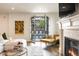 Inviting living room features a fireplace, ample seating, and view of the backyard pool at 5455 E Cedar Ave, Denver, CO 80246