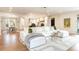 Spacious living room open to dining area and kitchen with a large sectional sofa at 5455 E Cedar Ave, Denver, CO 80246