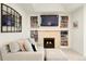 Cozy living room boasts built-in bookshelves, a fireplace, and comfortable seating at 5455 E Cedar Ave, Denver, CO 80246