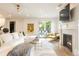 Bright living room boasts a fireplace, French doors to the pool, and comfortable seating at 5455 E Cedar Ave, Denver, CO 80246