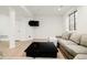 Cozy living room with a comfortable sofa and a mounted television at 5455 E Cedar Ave, Denver, CO 80246