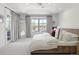The airy primary bedroom features a tray ceiling, a large window, and french door access at 5455 E Cedar Ave, Denver, CO 80246