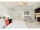 Bright primary bedroom with sitting area, fireplace, and ensuite bathroom access at 5455 E Cedar Ave, Denver, CO 80246
