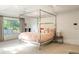 Main bedroom with natural light streaming through the large window, highlighting the bed at 5455 E Cedar Ave, Denver, CO 80246