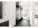 Mudroom with storage, a bench, and dark hexagonal tile floors at 5455 E Cedar Ave, Denver, CO 80246