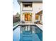 An outdoor pool with patio featuring an outdoor fireplace and access to the house at 5455 E Cedar Ave, Denver, CO 80246