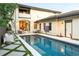 A gorgeous outdoor pool features stone tile, exterior access, and serene backyard space at 5455 E Cedar Ave, Denver, CO 80246
