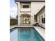 A luxurious pool area with modern design elements and a covered patio, perfect for outdoor entertaining at 5455 E Cedar Ave, Denver, CO 80246