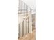 Elegant staircase features white risers, wood treads, and black wrought iron balusters at 5455 E Cedar Ave, Denver, CO 80246